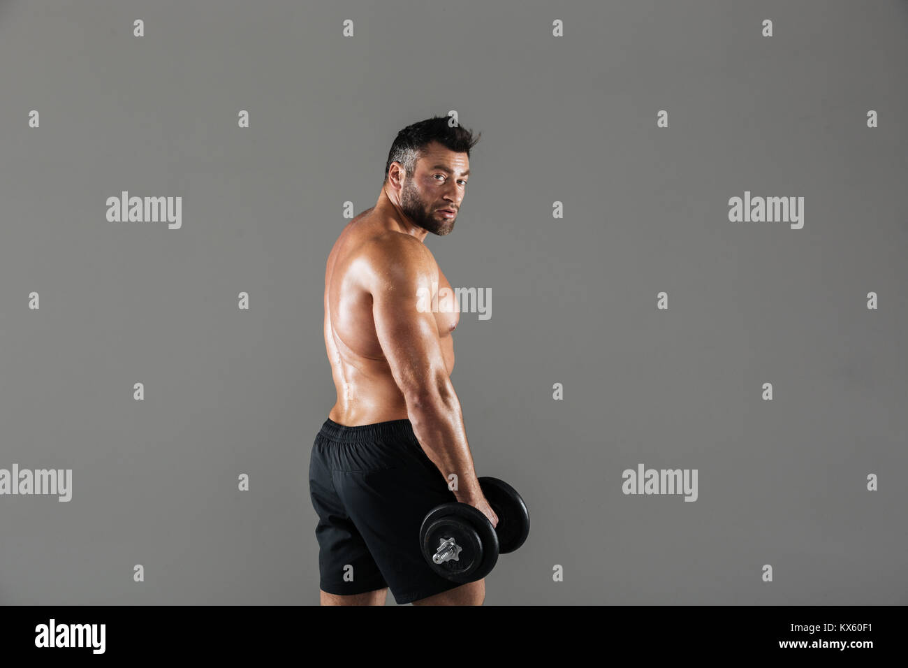 Male Bodybuilder Side View Rows Side view portrait of a serious strong shirtless male bodybuilder ...