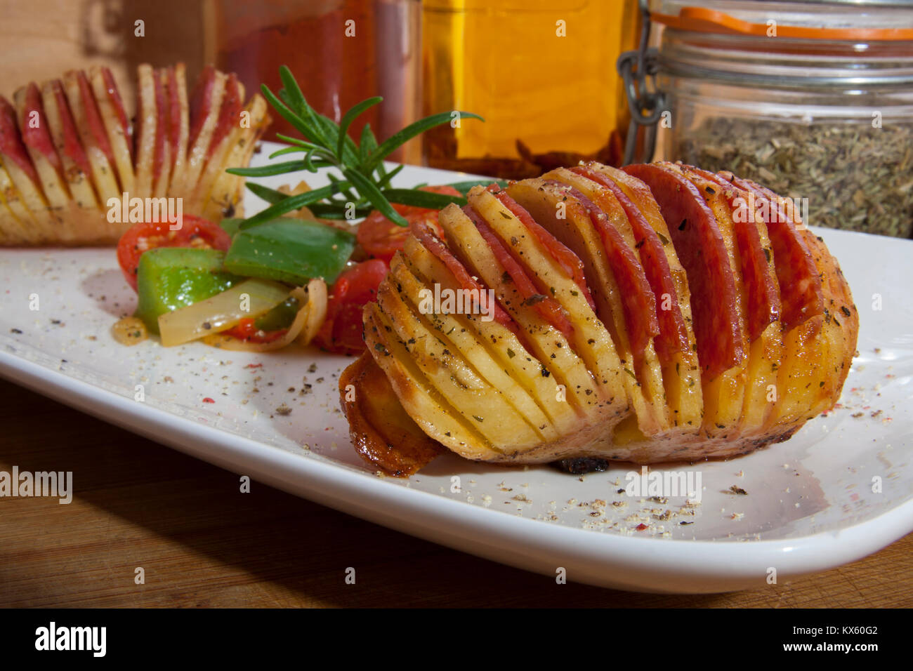 Hasselback potato stuffed with salami and vegetables Stock Photo Alamy