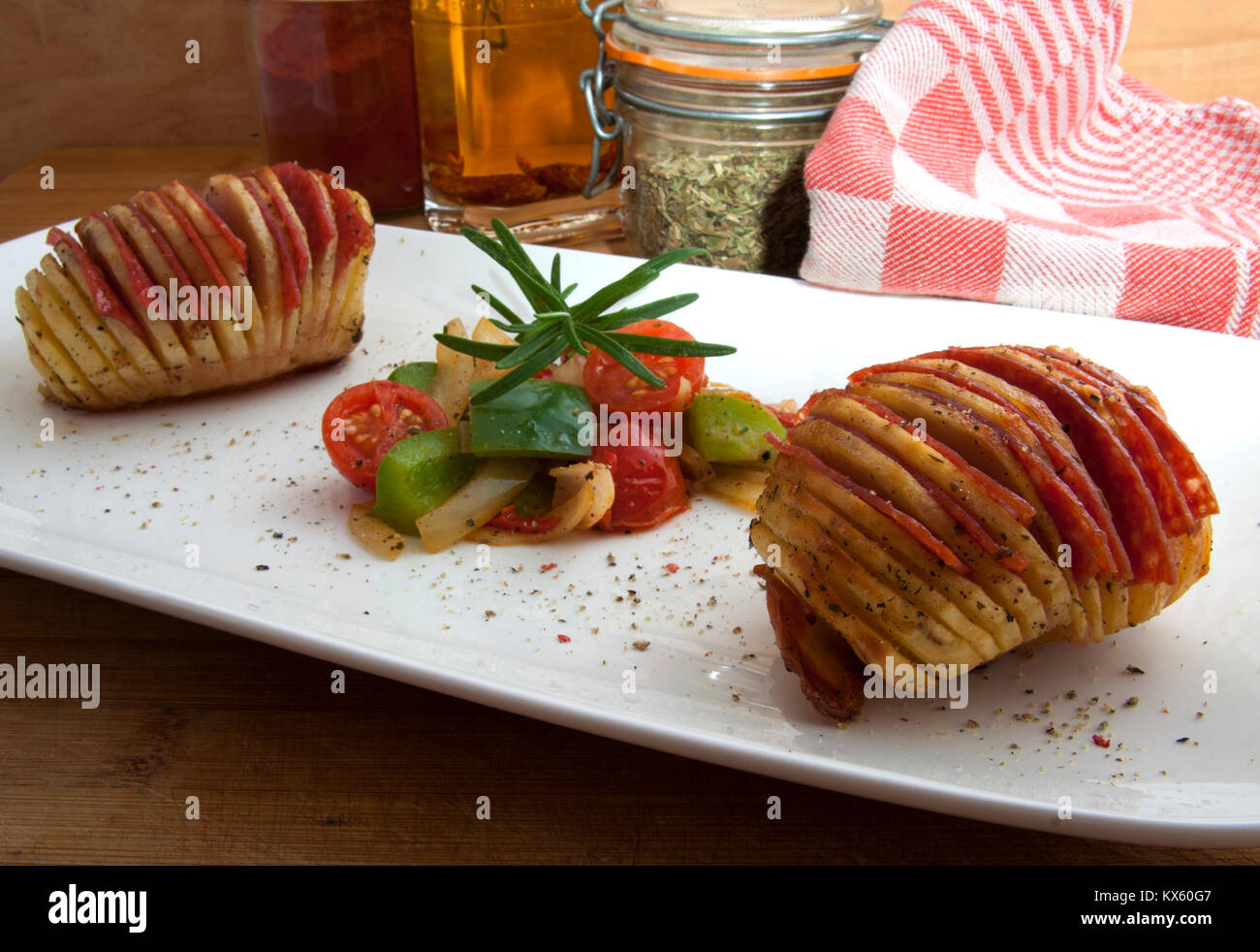 Hasselback potato stuffed with salami and vegetables Stock Photo Alamy