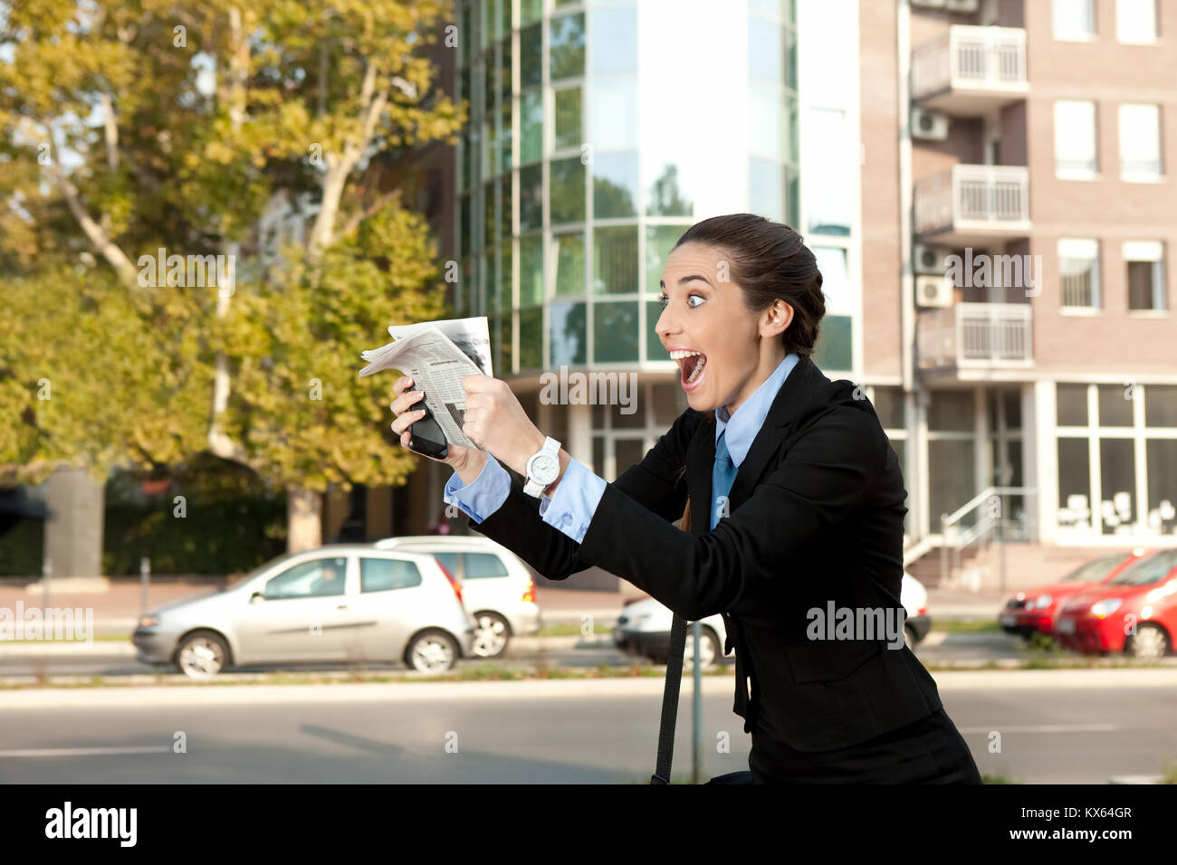 excited businesswoman with newspaper excellent news Stock Photo Alamy