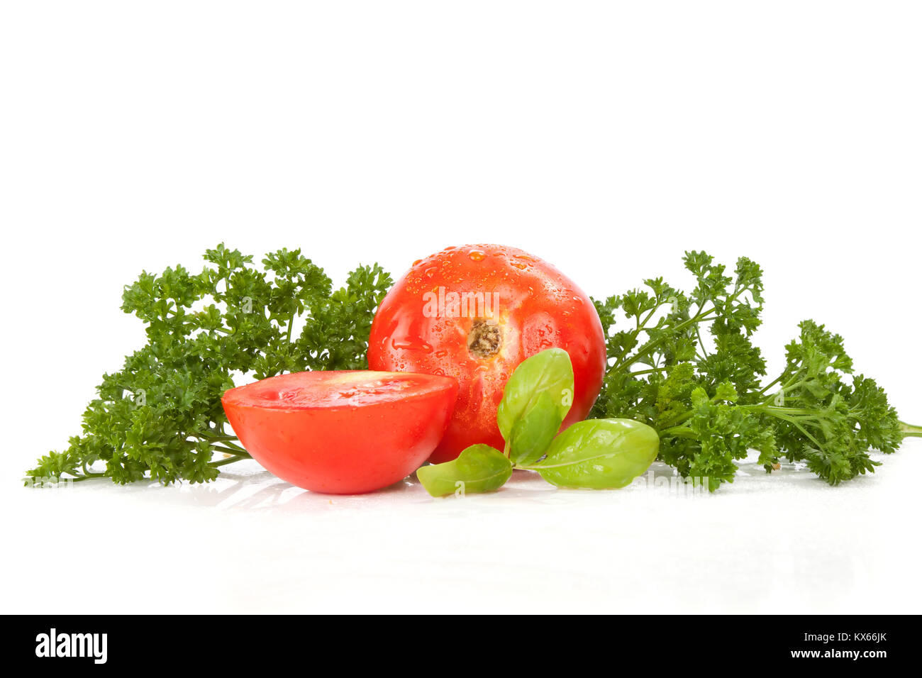 fresh tomato with leaves of parsley and basil Stock Photo - Alamy