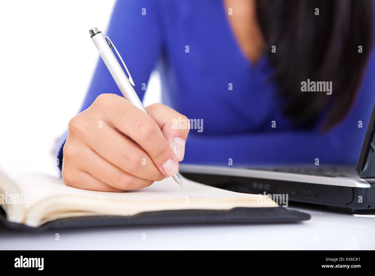 females hand making note, (hand with pen in focus Stock Photo - Alamy