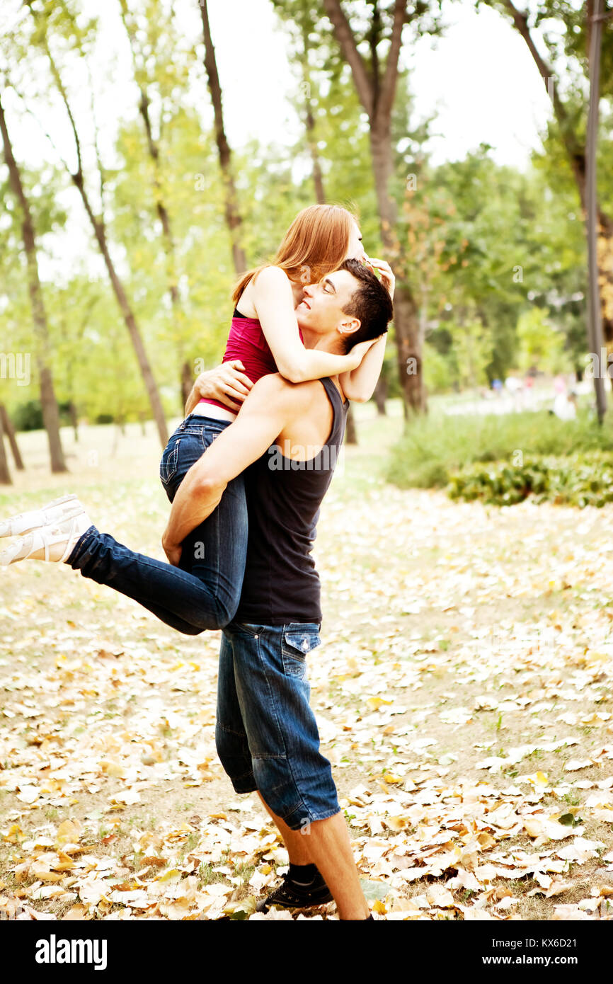 attractive young couple playing together in park Stock Photo - Alamy
