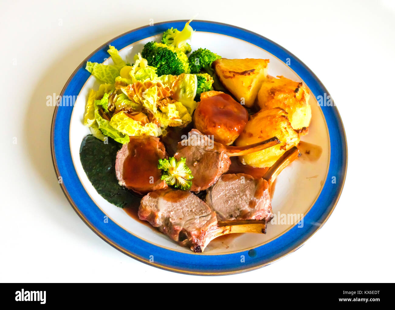 English dinner Roast rack of lamb broccoli cabbage roast potatoes mint