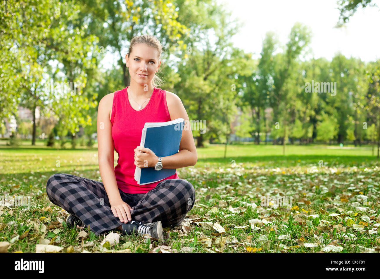 girl-student with book in park Stock Photo - Alamy