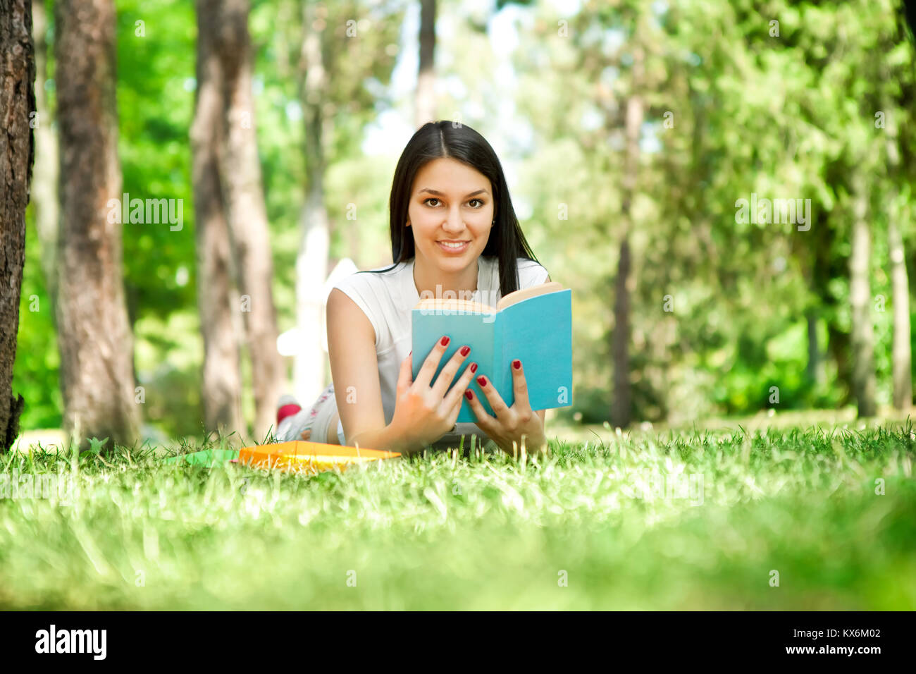 girl with book in park Stock Photo - Alamy