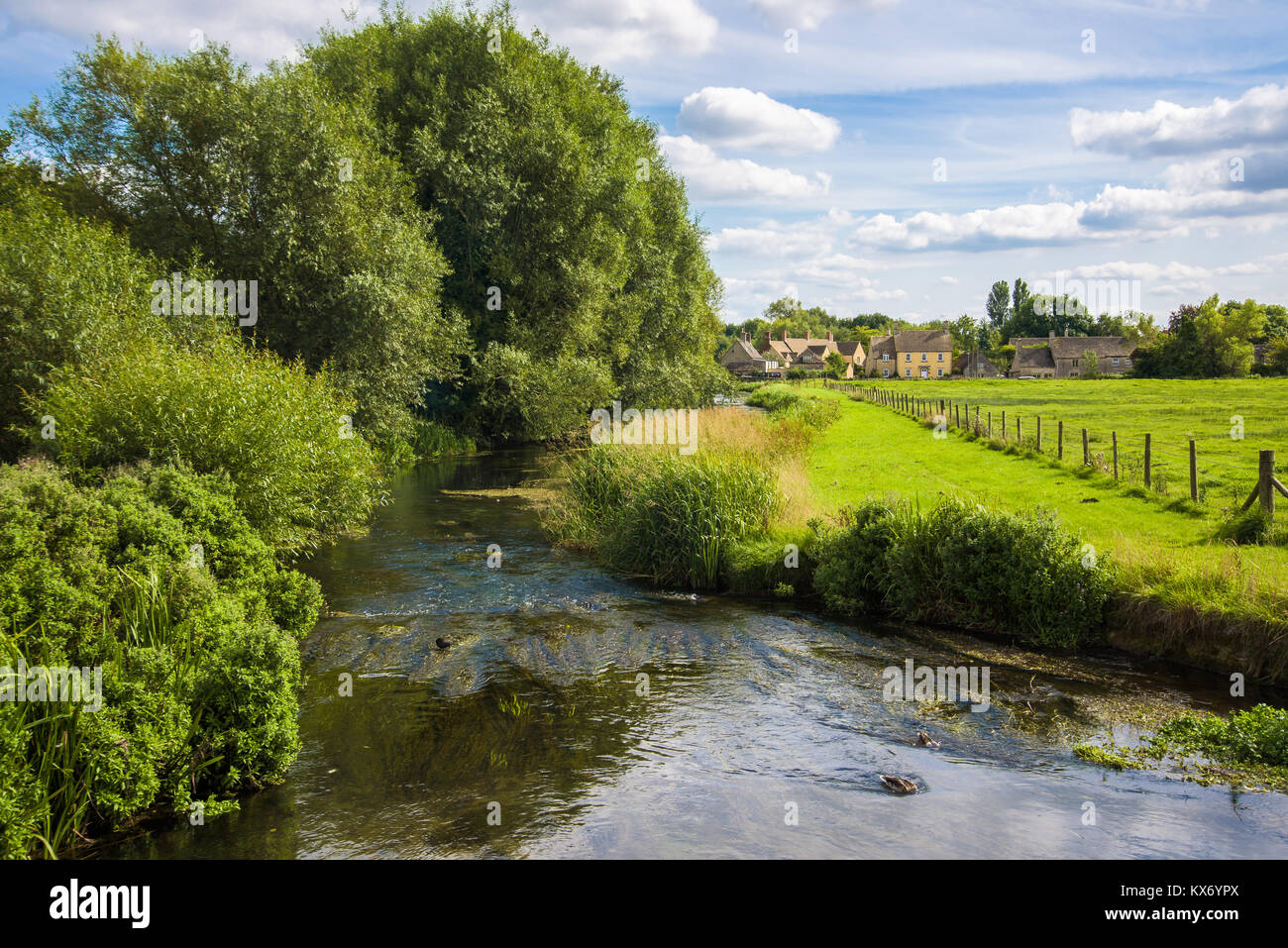 The Mill pond on a partly cloudy summer day. Fairford, Gloucestershire, England. Stock Photo
