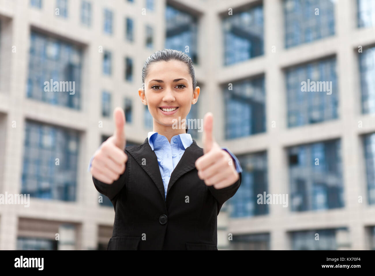 successful businesswoman outdoor showing thumbs up Stock Photo - Alamy