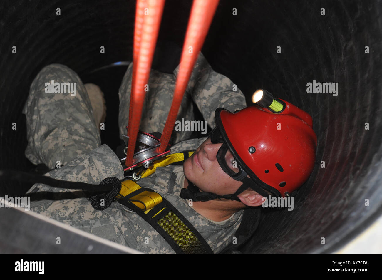 DENVER-- Spc. James L. Moseley, a combat engineer for the 118th Sapper Co, prepares to descend 60 feet into a manhole during a confined-space rescue training mission that took July 24. Soldiers from the 118th are harnessed to a tripod that allows their team mates to carefully lower them to the bottom of the obstacle in order to rescue a casualty and safely return them to the surface for medical attention. The training took place during the annual Vigilant Guard exercise held throughout Colorado Stock Photo