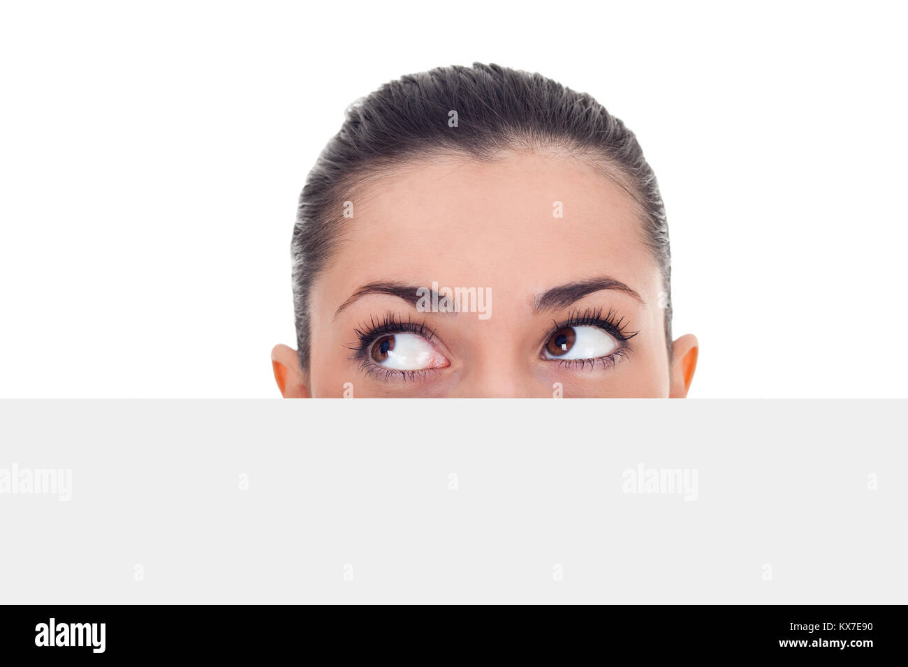 woman peeking hidden over blank billboard and looking in side,  isolated on white background Stock Photo