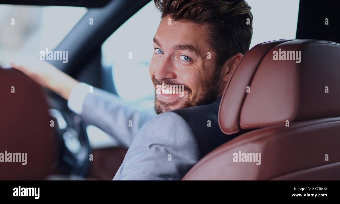 Portrait of an handsome smiling business man driving his car Stock ...