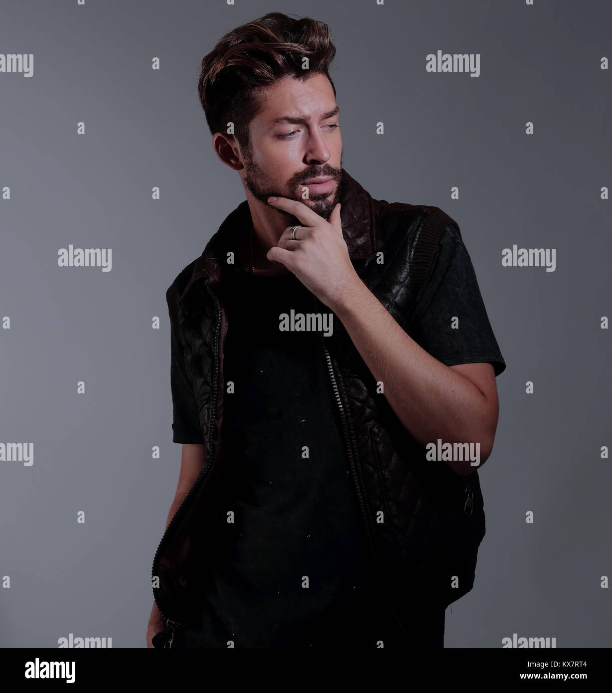 Portrait of a pensive handsome man over gray background Stock Photo - Alamy