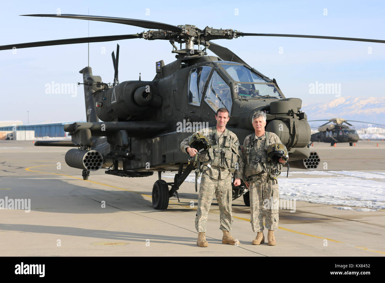 US Army National Guard veteran AH-64 Apache helicopter pilot flying and  handing over to young pilot after interview with TV media crew Stock Photo  - Alamy