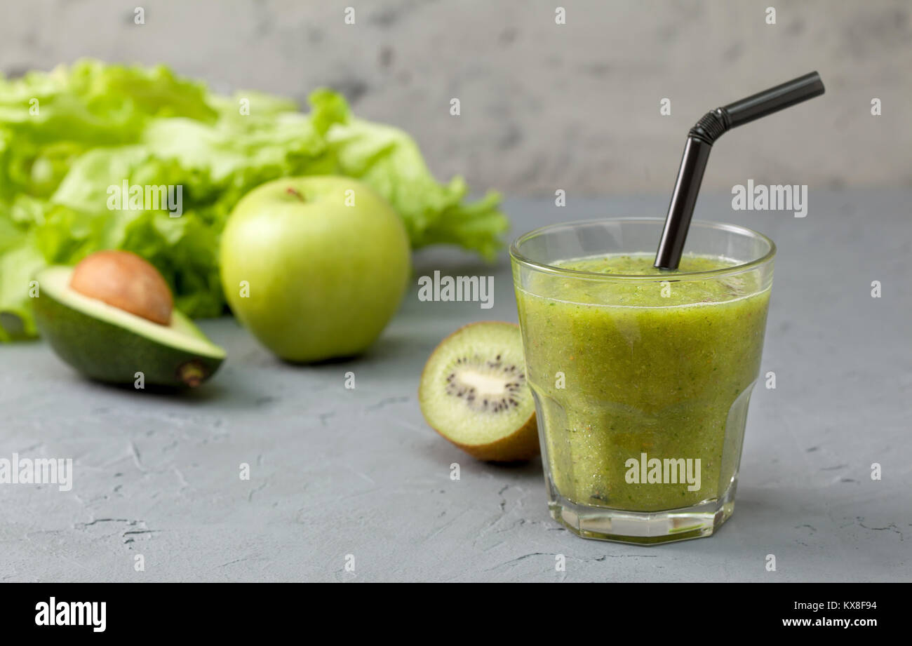 green smoothies in glassful with fresh vegetables and herbs:  avocado, apple, kiwi. detox smoothies Stock Photo