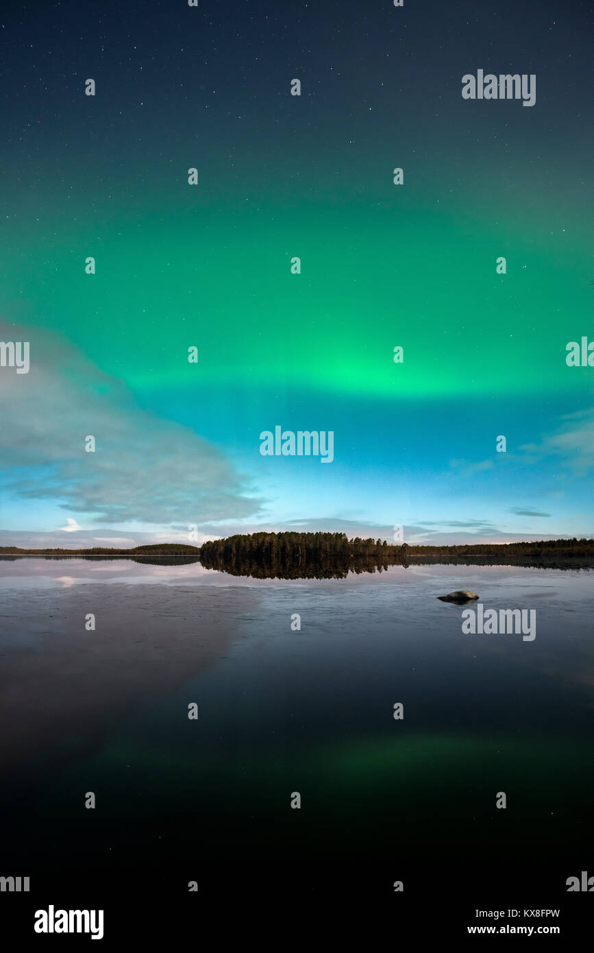 Northern Lights behind fast moving clouds in Kurjenrahka National Park, Finland Stock Photo