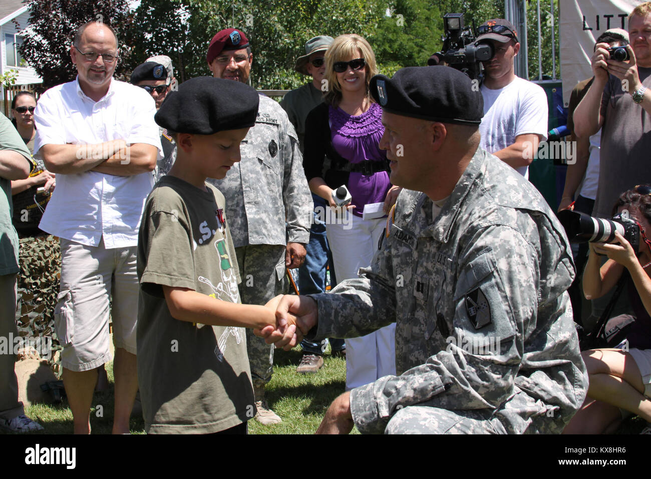 Draper, Utah - The Utah National Guard along with countless family, friends and volunteers from the Make-a-Wish Foundation fulfilled 7-year-old Mark Jeanes wish of becoming a Soldier by making him an honorary airborne paratrooper at his home July 30.  Mark, who suffers from a rare life-threatening illness, was surprised at his home by family, friends, and both current and former Servicemembers spanning all branches of service.  Volunteers turned his backyard into an Army themed playground, with the highlight being a restored WWII era jeep.  The event was a surprise by the Make-a-Wish Foundatio Stock Photo