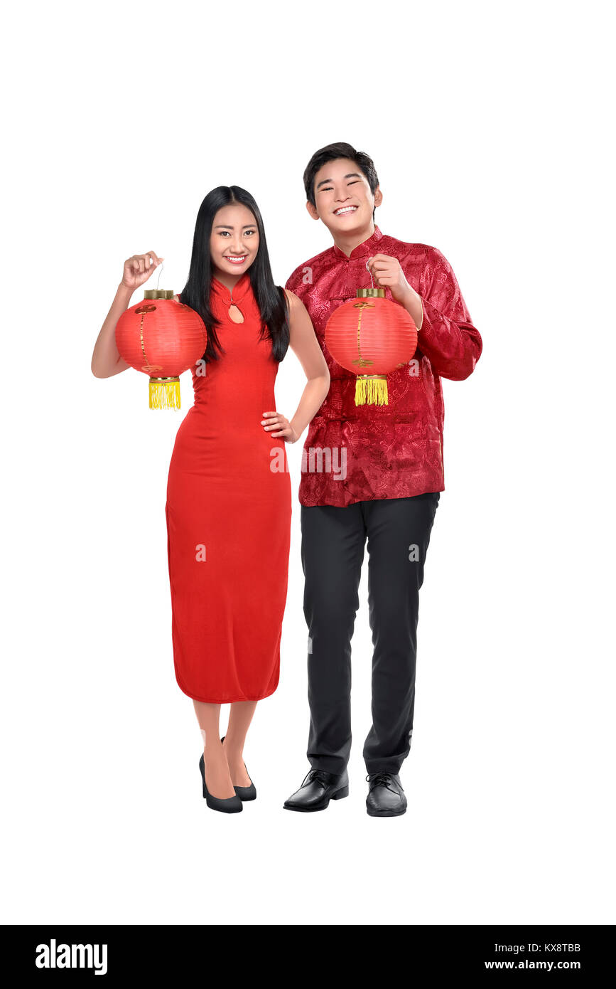 Portrait of chinese couple holding red lanterns posing isolated over white background Stock Photo