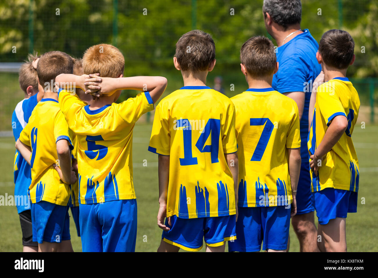Children soccer team. Kids standing together on the pitch. Youth