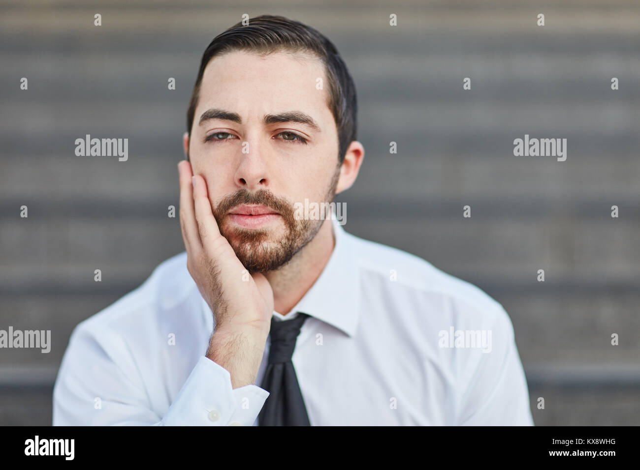 Business man worries about problem and looks pensive Stock Photo