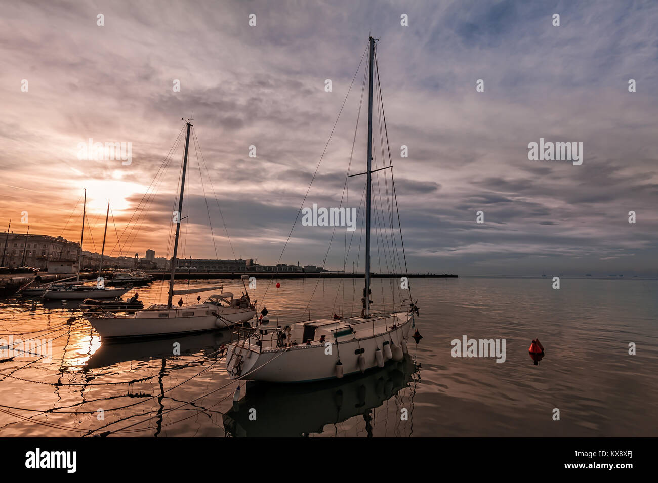 Pleasure boats moored in harbor at sunset. Trieste Italy Stock Photo