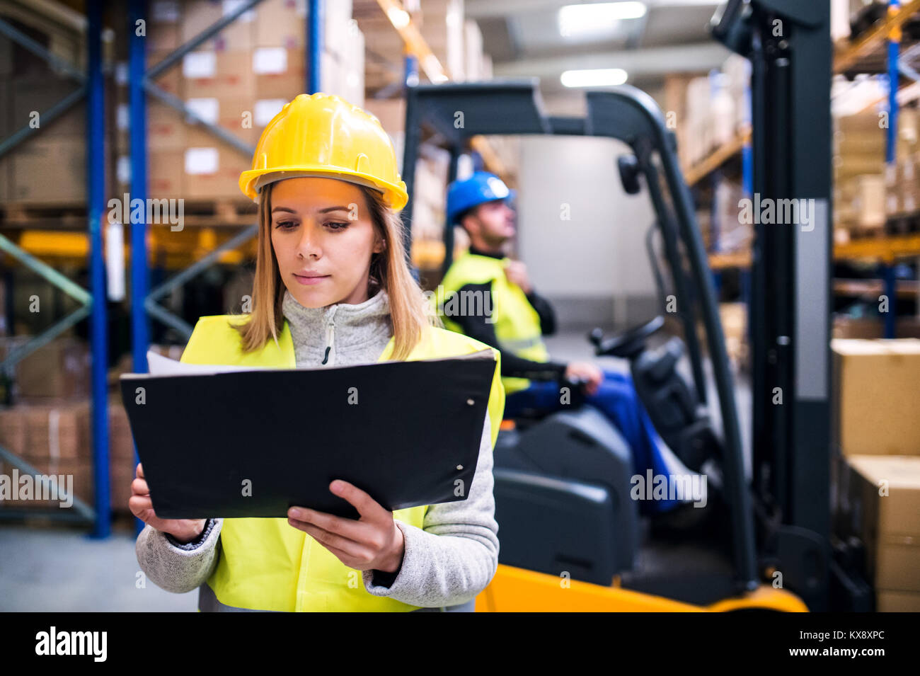 Young warehouse workers working together Stock Photo - Alamy
