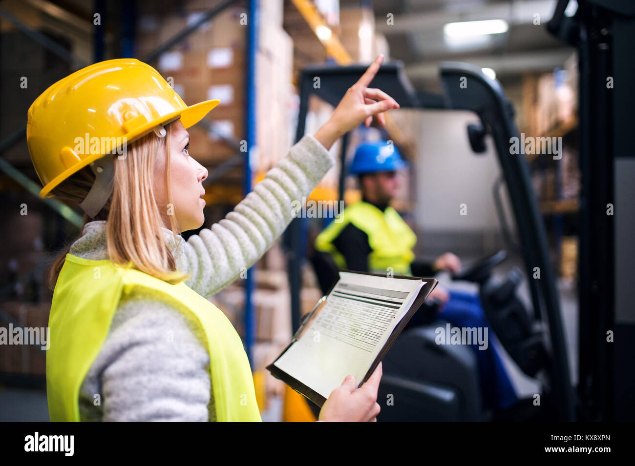 Young warehouse workers working together Stock Photo - Alamy