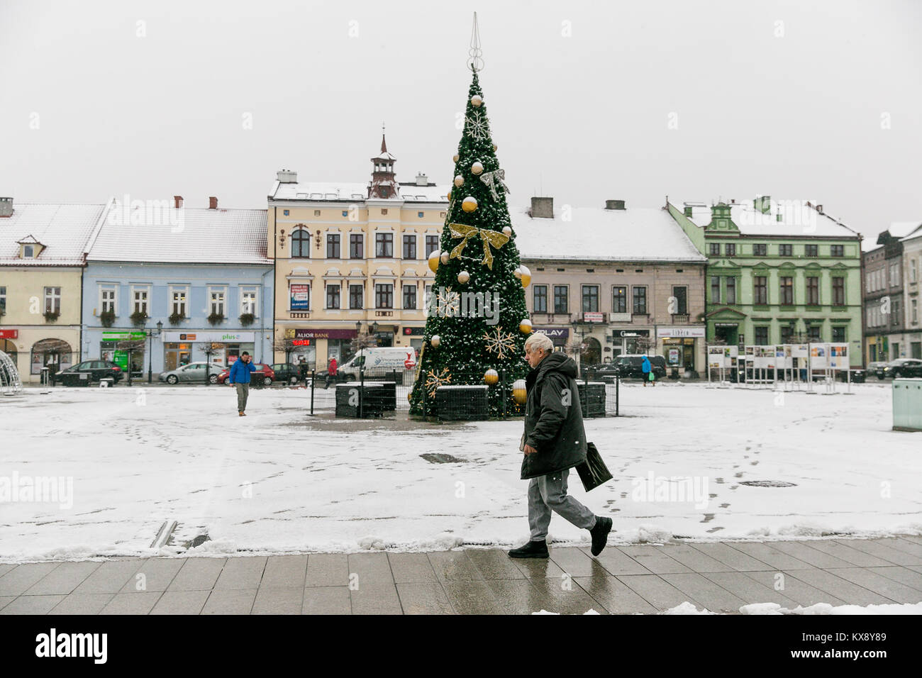 Christmas Tree standing at the center of covered with snow Big Old Market Square in Oswiecim