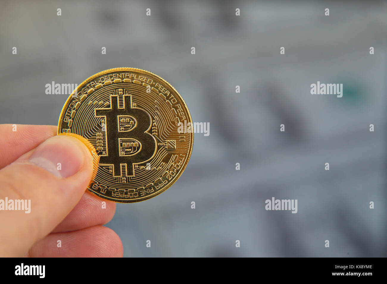 male hand holding bitcoin, dollar background,macro shot Stock Photo