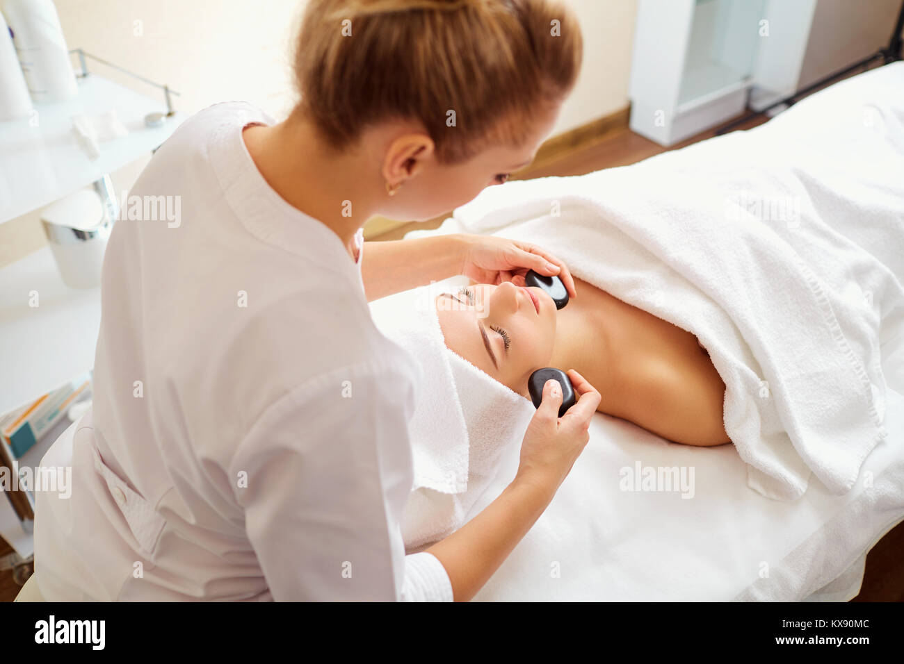 Massage face woman stone therapy. Stock Photo