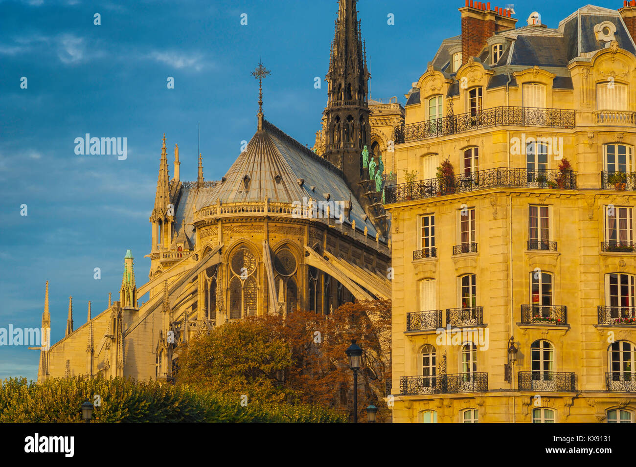 Paris architecture, the east end of Notre Dame Cathedral alongside a typical 19th century apartment building on the Ile de la Cite in Paris, France. Stock Photo