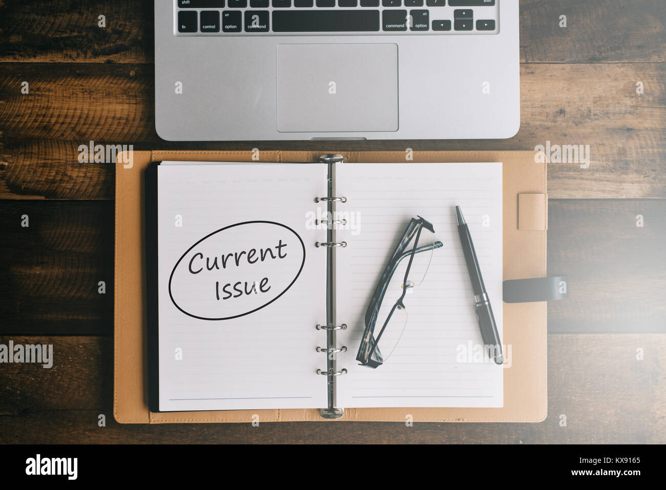 Notebook, laptop, pen and spectacles on a wooden table. current issues concept Stock Photo