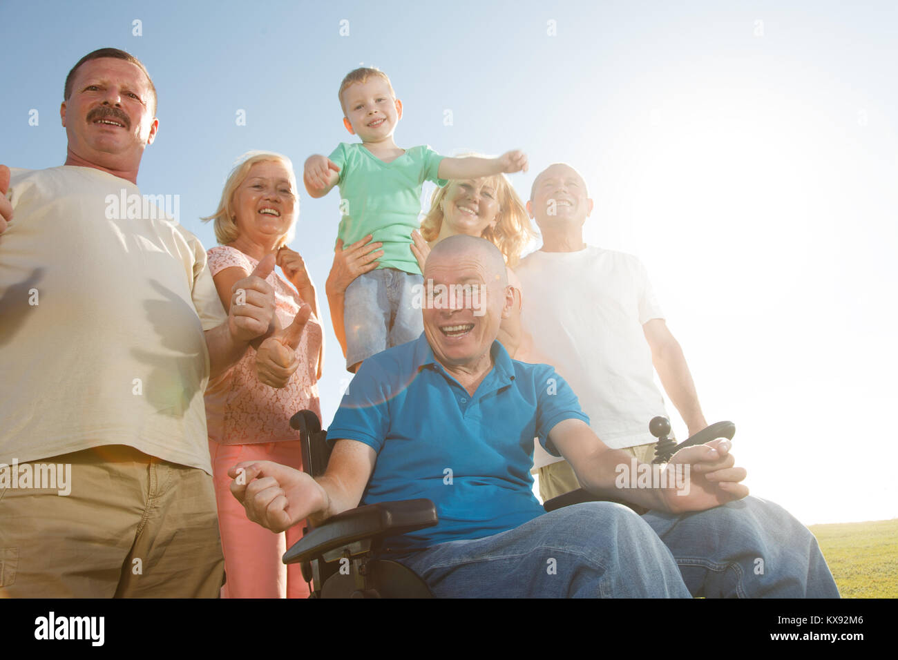 Disabled man with group of people outside. Stock Photo