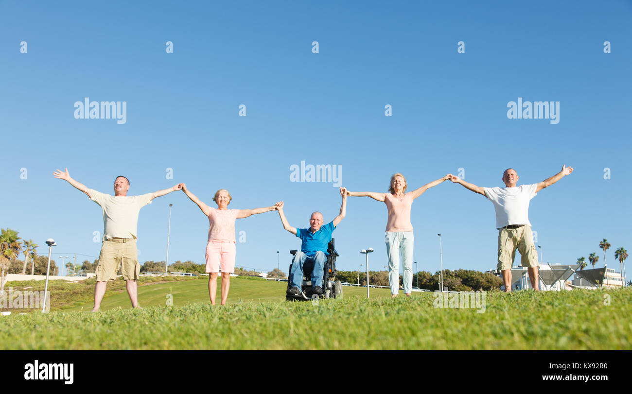 Disabled man with family showing unity. Stock Photo