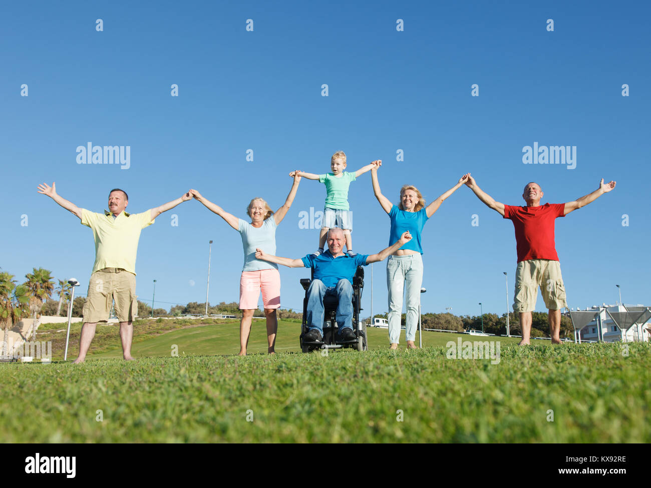 Disabled man with family showing unity. Stock Photo