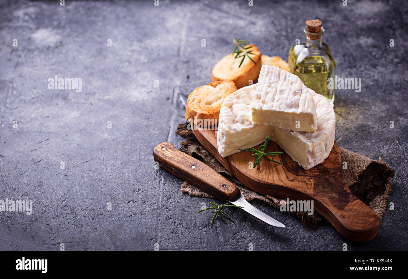 Camembert cheese with rosemary on wooden board Stock Photo Alamy