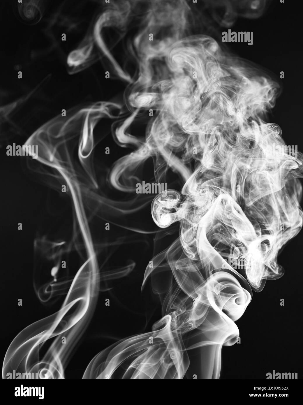 A whisp of white smoke against the black background Stock Photo - Alamy