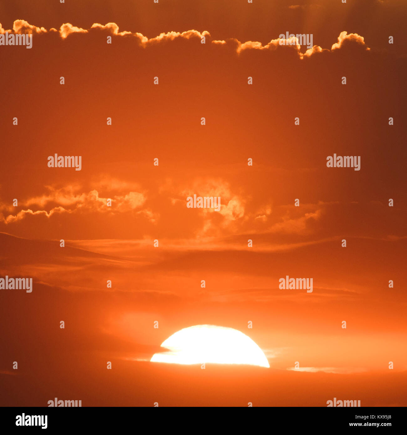 Sunset behind the clouds, orange sky. beautiful sunset Stock Photo - Alamy