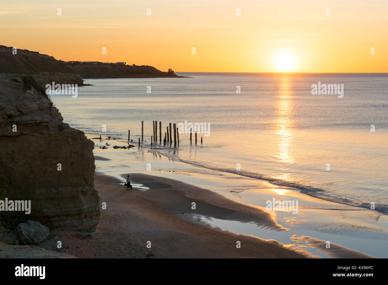 The old jetty ruins on Port Willunga Beach, South Australia just before sunset. Known as the sticks by locals and situated within the Fleurieu Peninsu Stock Photo