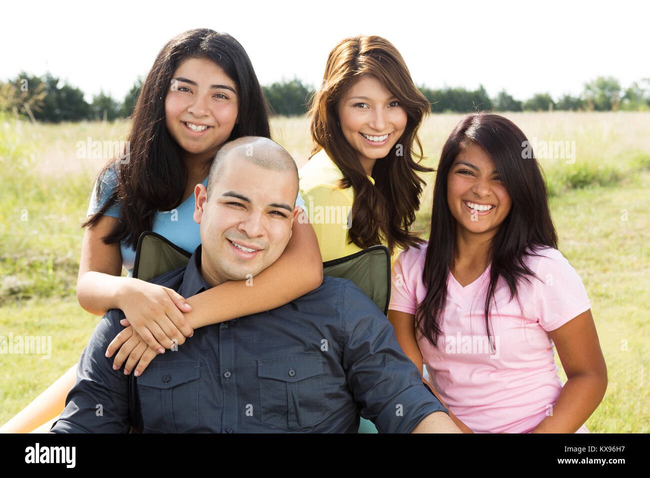 Hispanic father and his daughters. Stock Photo