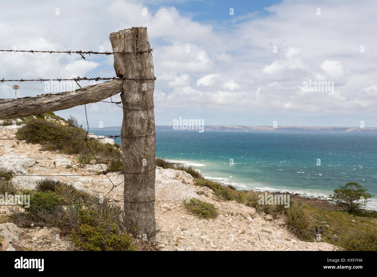 Old rural barbed wire fence with wooden posts, found on the Fleurieu