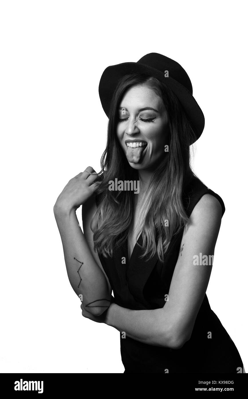 Young woman in hat laughing playing on white background Stock Photo