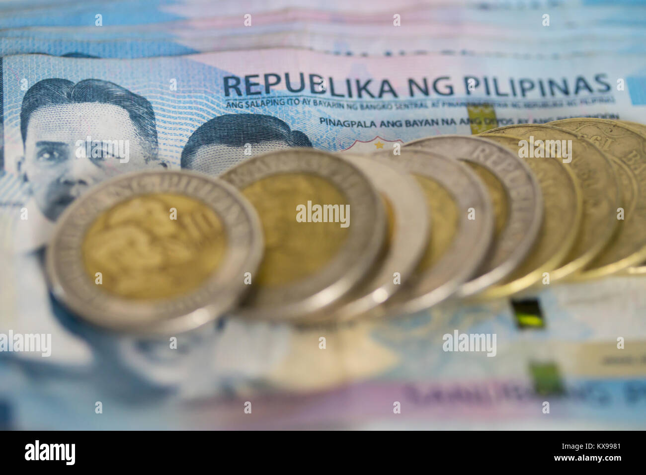 Concept image of Filipino coins and paper money indicating economy of the Philippines Stock Photo