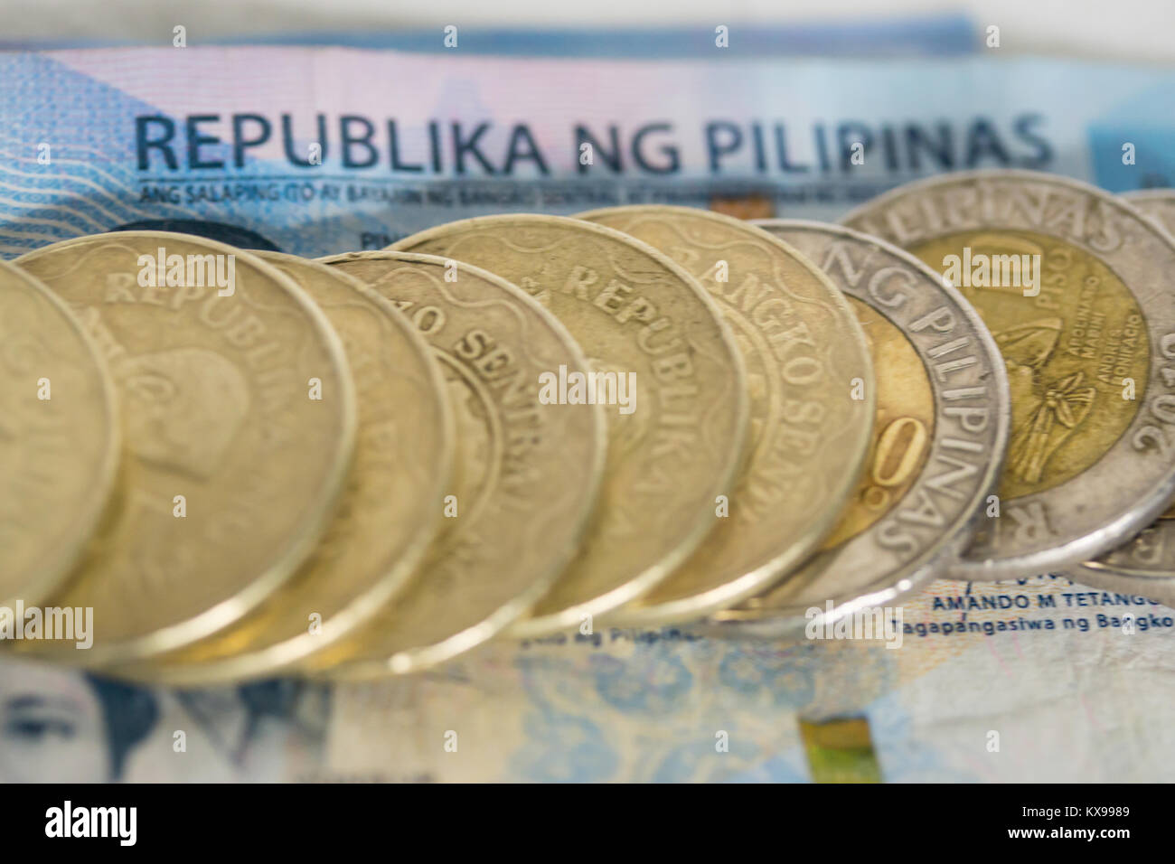 Concept image of Filipino coins and paper money indicating economy of the Philippines Stock Photo