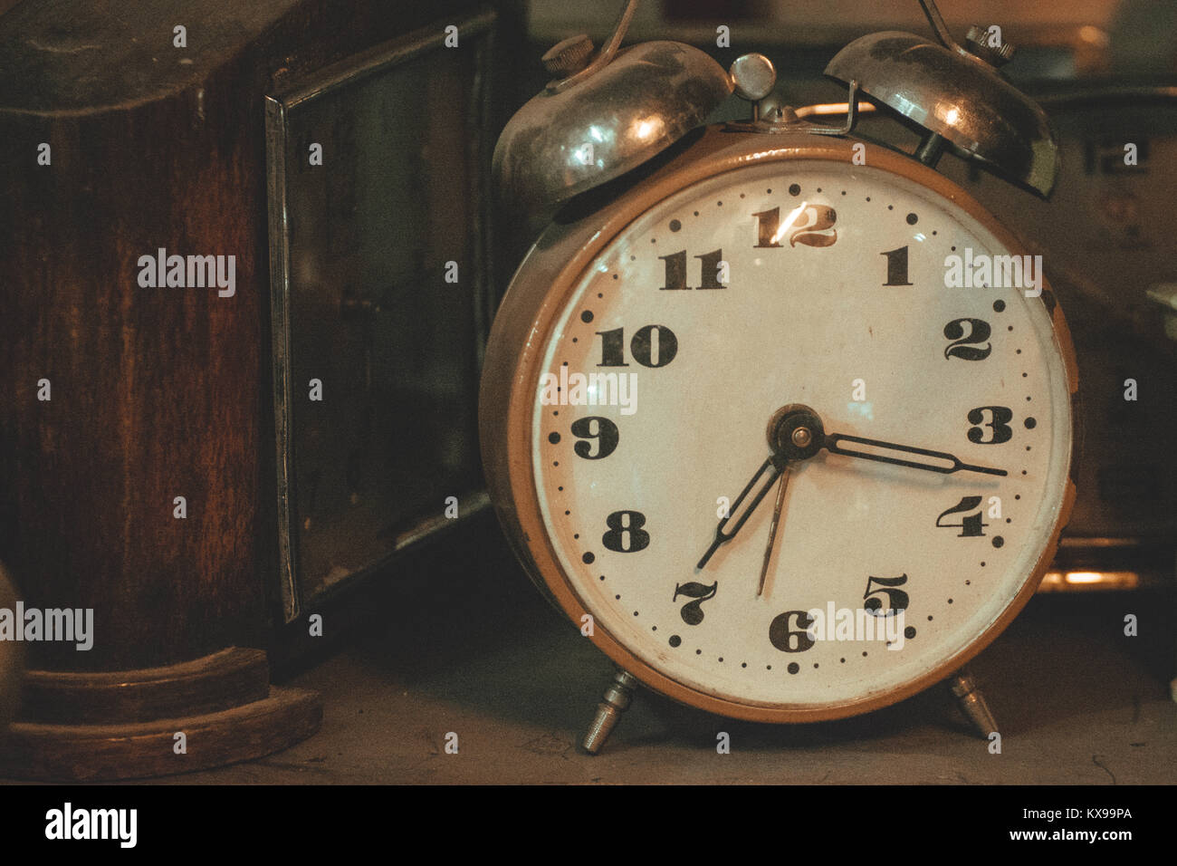 Vintage background with old retro alarm clock on table Stock Photo - Alamy