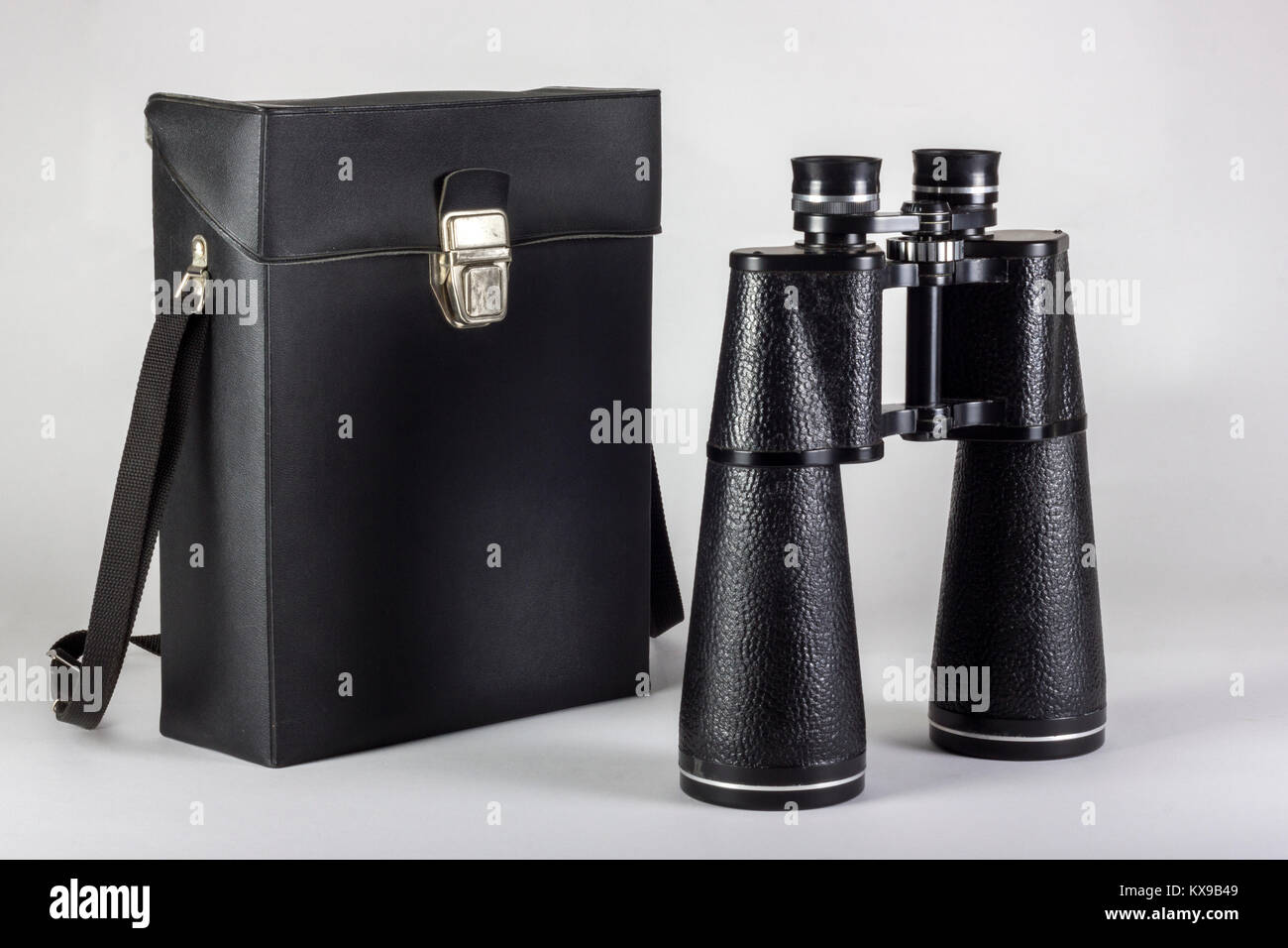 Old Soviet binoculars with leather bag isolated on white Stock Photo