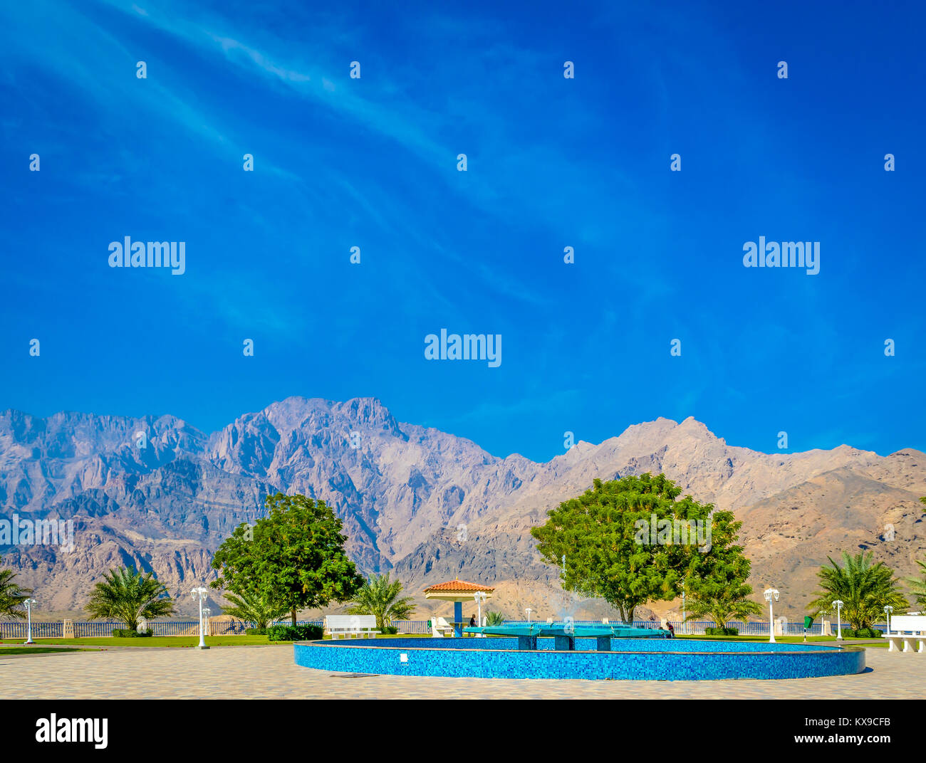A perfect picnic spot with blue sky, greenery and mountains. On a bright, sunny day in Muscat, Oman. Stock Photo