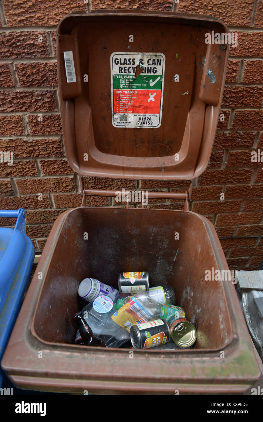 Plastic and glass bottles, glass jars and tin containers in a recyling bin. Stock Photo