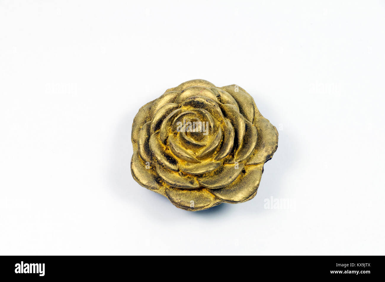 Ornamental, gold painted chocolate rose. Stock Photo