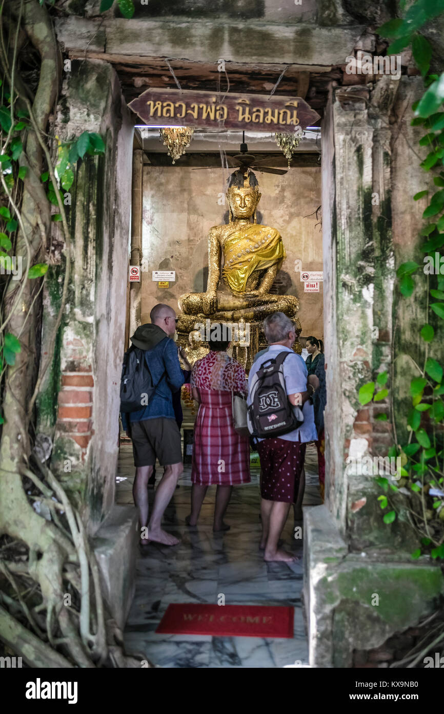 Western tourist visiting the Statue of Buddha, Ordination Hall, Bang Kung Camp, Samut Songkhram, Thailand. Stock Photo