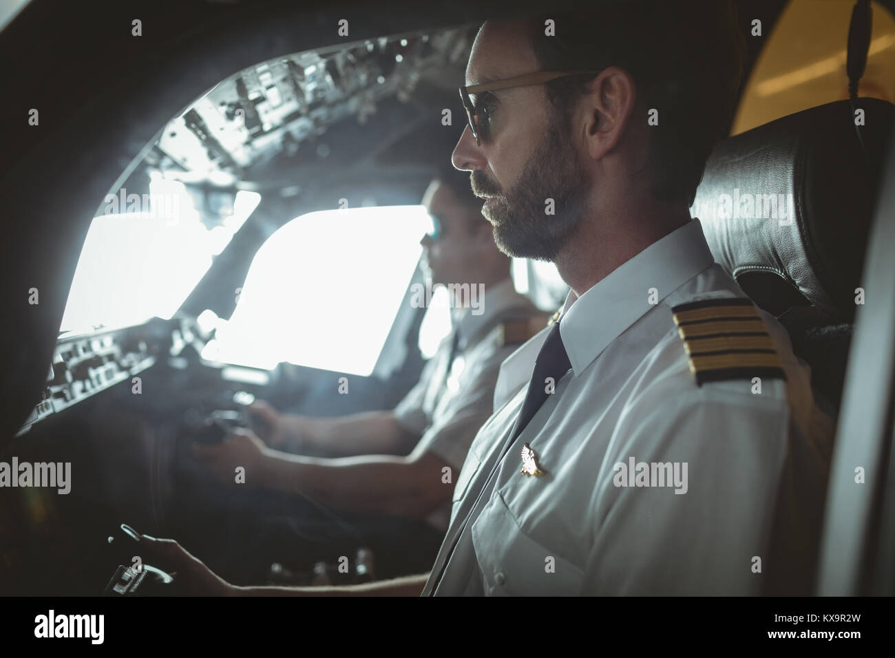 Pilot and copilot flying an airplane Stock Photo